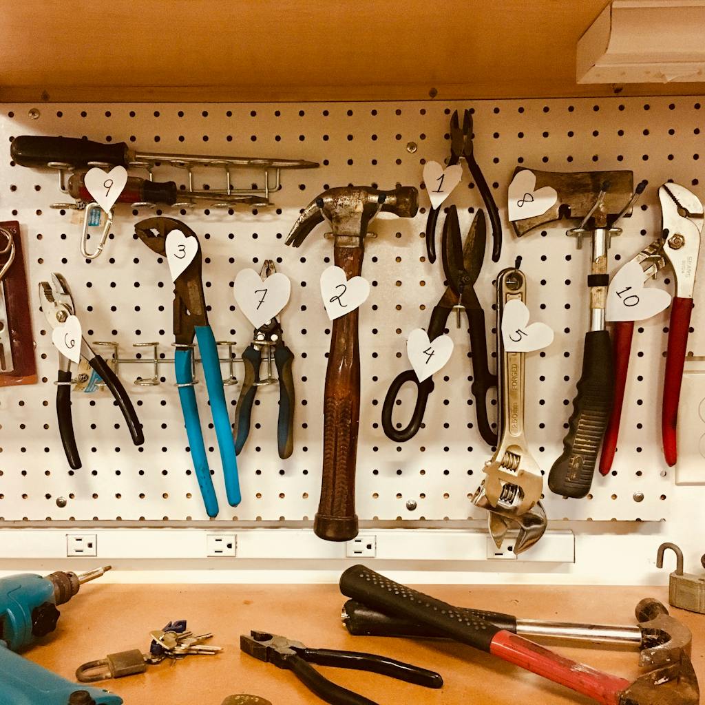 Neatly arranged tools on a pegboard in a well-lit workshop setting.