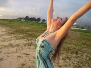 Ashley Lewis arms thrown back in the hawaii wind